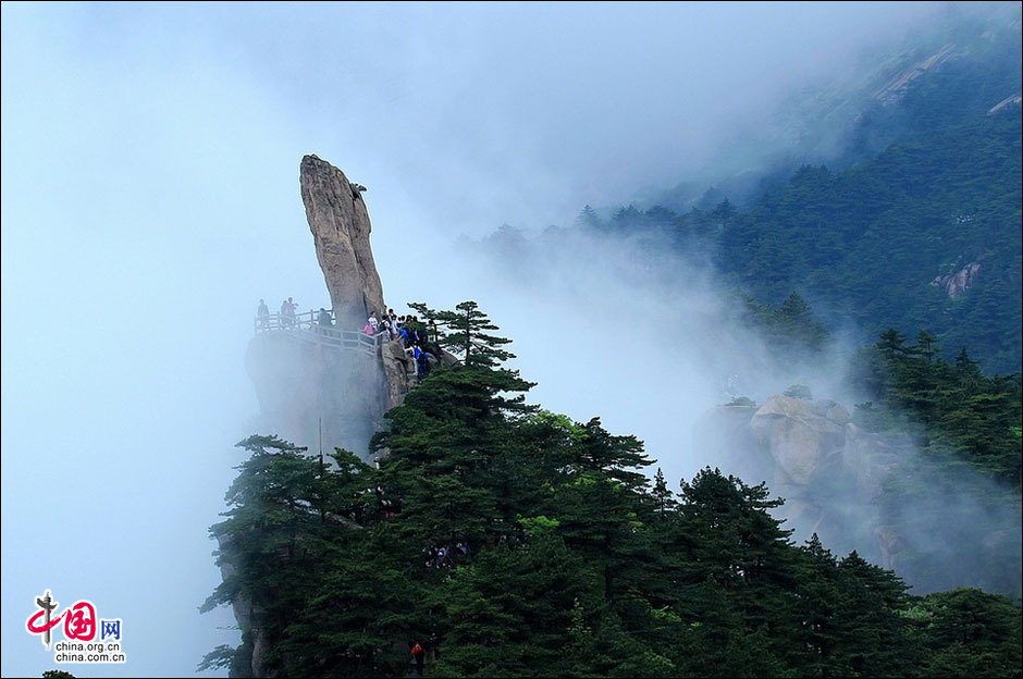 Huangshan Mountain, listed as a UNESCO cultural and natural heritage and World Geopark, boasts of spectacular landscapes thick with vegetation and lofty peaks. The 154-square-kilometer sight-seeing area possesses four unique scenes: peculiarly shaped granite rocks, waterfalls, pine trees and views of the clouds from above. The Flying over Rock, the Stone Monkey Gazing over the Sea of Clouds, the Brush pen-liked Rock and many other renowned scenic spots attract streams of visitors to the marvelous mountain every day. (China.org.cn)