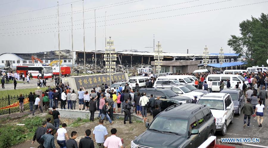 People gather at the accident site after a fire occurred in a slaughterhouse owned by the Jilin Baoyuanfeng Poultry Company in Mishazi Township of Dehui City, northeast China's Jilin Province, June 3, 2013. Death toll from the poultry processing plant fire on Monday morning has risen to 119. (Xinhua/Wang Haofei)