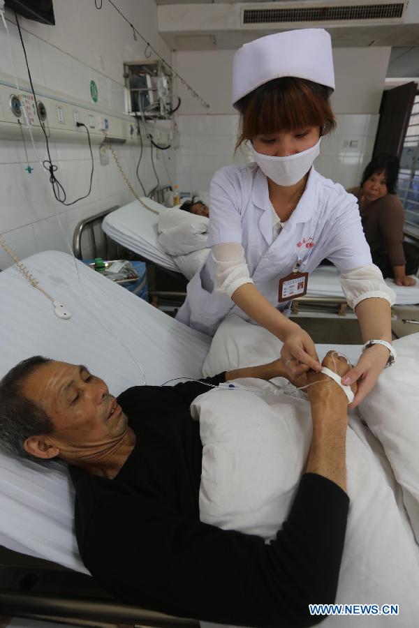 An injured person receives treatment at a hospital in Shaodong County, central China's Hunan Province, June 3, 2013. A gas explosion happened at the Simachong coal mine on Sunday. Ten people have been confirmed dead during the explosion. The rescue work has ended and the injured have been sent to hospital for treatment. (Xinhua/Guo Guoquan)