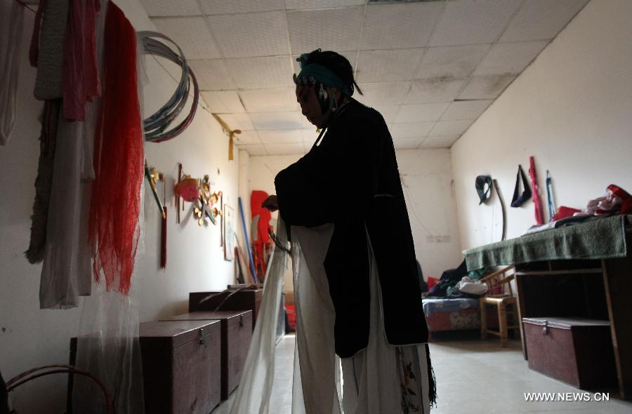 In this file photo taken on Jan. 31, 2012, an actress prepares for a performance at the Chen's Garden Sichuan Opera Troupe in suburban Chengdu, capital of southwest China's Sichuan Province. Sichuan opera is one of the oldest forms of Chinese opera, distinguished by face-changing, fire-spitting and other stunts. Regionally Chengdu remains to be the main home of Sichuan opera, while other influential locales include Yunnan, Guizhou and other provinces in southwest China. (Xinhua/Xue Yubin)  