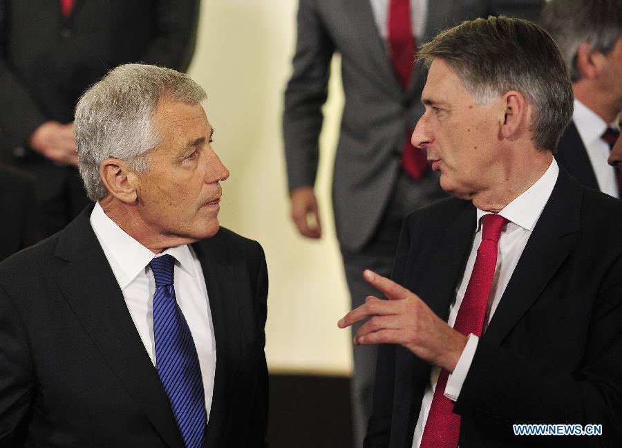 United States Secretary of Defense Chuck Hagel (L) talks with United Kingdom Secretary of Defense Philip Hammond during a photo session of a NATO Defense Minister Meeting at its headquarters in Brussels, capital of Belgium, June 4, 2013. NATO defense ministers convened on Tuesday to examine cyber security as a collective defense issue amid mounting concerns over the threat posed by cyber attacks. (Xinhua/Ye Pingfan) 