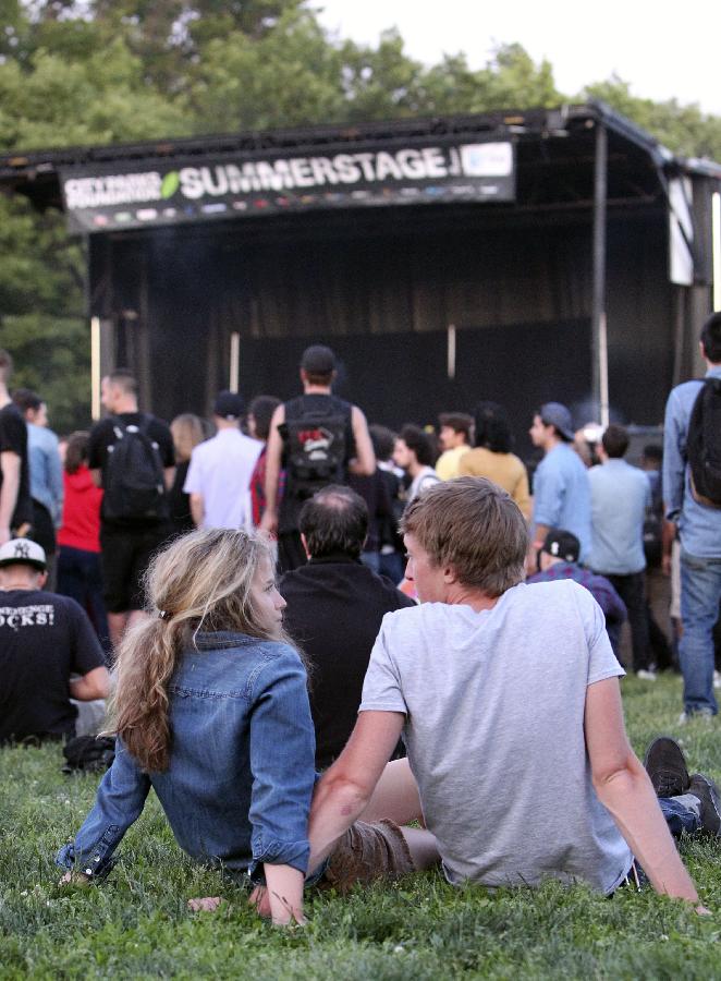 People watch a performance of SummerStage festival in the Brooklyn borough of New York, the United States, June 4, 2013. With a history of over 20 years, SummerStage, a program of City Parks Foundation, presents performances of outstanding artistic quality free of charge to serve the diverse communities of New York City. (Xinhua/Cheng Li) 