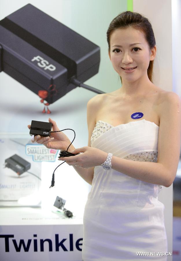 A model presents a FSP power supply product at Computex Taipei 2013 exhibition, in Taipei, southeast China's Taiwan, June 4, 2013. The five-day exhibition opened here on Tuesday. (Xinhua/Tao Ming)