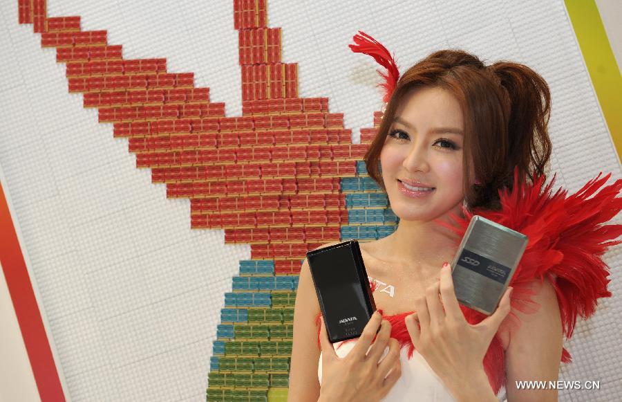 A model presents ADATA storage products at Computex Taipei 2013 exhibition, in Taipei, southeast China's Taiwan, June 4, 2013. The five-day exhibition opened here on Tuesday. (Xinhua/Tao Ming) 