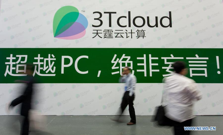 Visitors walk past a board at the exhibition area of cloud computing service during the 5th China Cloud Computing Conference in Beijing, capital of China, June 5, 2013. The conference kicked off on June 5. (Xinhua/Liu Xin) 