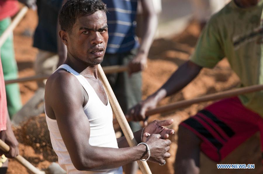 A worker takes a break in a sapphire mine in Ilakaka town, the famous sapphire town in southwest Madagascar, on May 31, 2013. Since the discovery of alluvial sapphire deposits in 1998, the population had boomed from 40 residents to near 60,000 by 2005, including many businessmen from Thailand, India, France, China, etc., most of whom dreamed to become rich in one night to find sapphires. Madagsacar, famous for its sapphire production, stood alongside Australia as one of the world's two largest sapphire producers at its peak period. There are still sapphire mines operating around Ilakaka, but most deposits are located deeper below the surface now, and miners have to work much harder to extract sapphires. Due to the deep location and political crisis, Madagascar has not managed to regain its former glory as a primary producer of sapphires. (Xinhua/He Xianfeng)