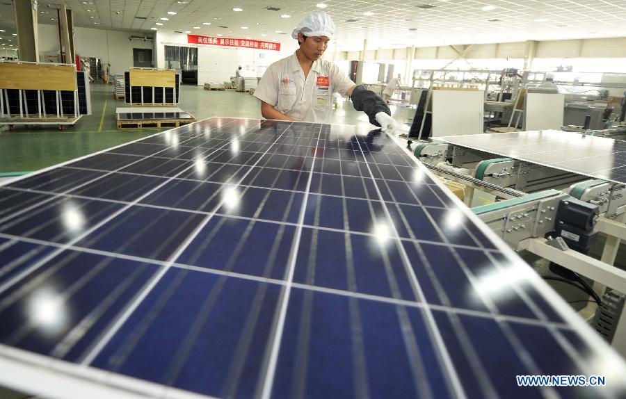 An employee assembles a piece of solar panel in a factory owned by photovoltaic products maker Yingli Solar in Tianjin, north China, June 5, 2013. Spokesman of China's Ministry of Commerce Shen Danyang said on June 5 China firmly opposes the European Commission's decision to slap provisional antidumping duties on Chinese solar panels. Shen added that it came despite herculean efforts and utmost sincerity from the Chinese side. On June 4, the European Commission announced its decision to introduce antidumping duties on solar panels imported from China. An interim punitive duty of 11.8 percent will apply to all Chinese solar panel imports starting from Thursday, and the duty will be raised to an average of 47.6 percent in two months if the two sides fail to find a solution. (Xinhua/Yue Yuewei)