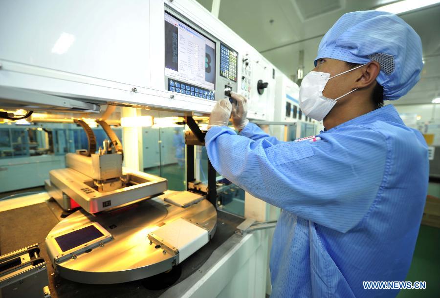 An employee operates an electronic machine at the silicon wafer processing workshop of the photovoltaic products maker Yingli Solar in Tianjin, north China, June 5, 2013. Spokesman of China's Ministry of Commerce Shen Danyang said on June 5 China firmly opposes the European Commission's decision to slap provisional antidumping duties on Chinese solar panels. Shen added that it came despite herculean efforts and utmost sincerity from the Chinese side. On June 4, the European Commission announced its decision to introduce antidumping duties on solar panels imported from China. An interim punitive duty of 11.8 percent will apply to all Chinese solar panel imports starting from Thursday, and the duty will be raised to an average of 47.6 percent in two months if the two sides fail to find a solution. (Xinhua/Yue Yuewei)
