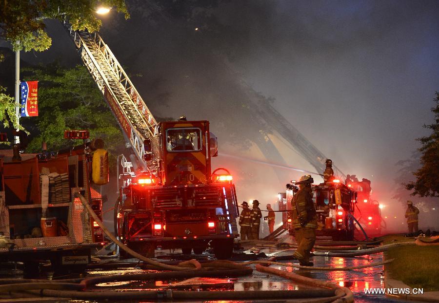 Firefighters work to cease fire at a hardware store on Pennsylvania Avenue SE in Washington, capital of the United States, June 5, 2013. At least two firefighters got wounded in the fire. (Xinhua/Zhang Jun) 