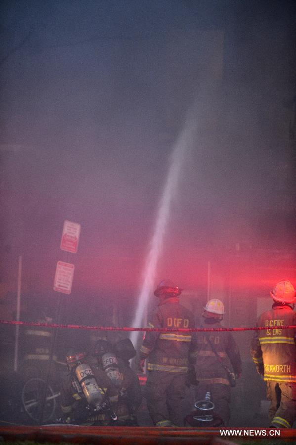 Firefighters work to cease fire at a hardware store on Pennsylvania Avenue SE in Washington, capital of the United States, June 5, 2013. At least two firefighters got wounded in the fire. (Xinhua/Zhang Jun) 