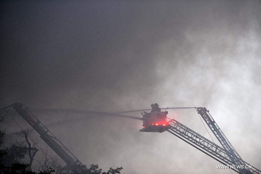 Firefighters work to cease fire at a hardware store on Pennsylvania Avenue SE in Washington, capital of the United States, June 5, 2013. At least two firefighters got wounded in the fire. (Xinhua/Zhang Jun) 