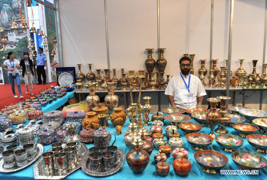 An exhibitor presents Indian products at the first China-South Asia Expo in Kunming, capital of southwest China's Yunnan Province, June 6, 2013. The five-day China-South Asia Expo opened here on Thursday, attracting over 1,400 exhibitors from Asian countries and regions. (Xinhua/Chen Haining)