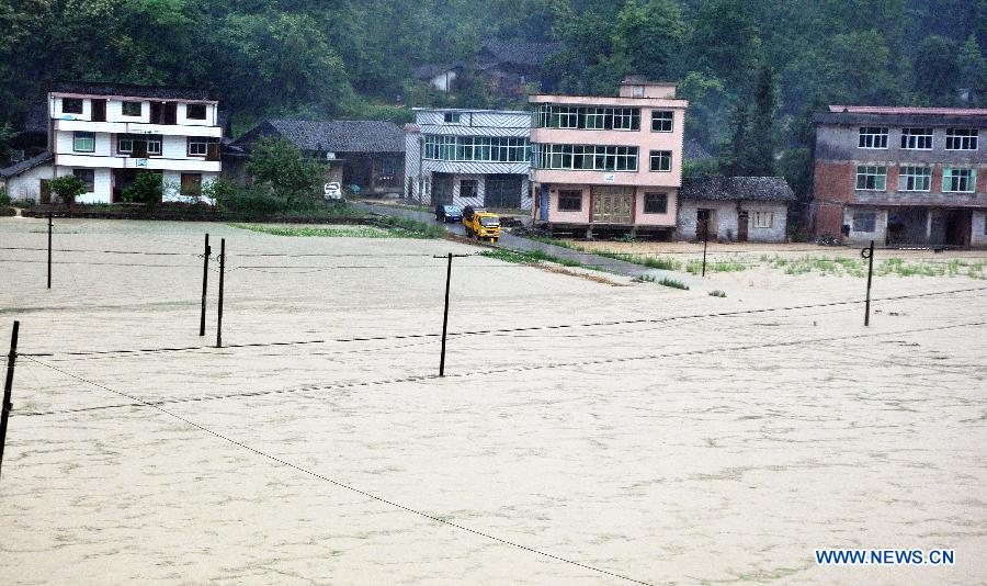 A road is flooded in Gaoluo Township, Xuan'en County, Enshi Tujia and Miao Autonomous Prefecture of central China's Hubei Province, June 6, 2013. Torrential rainfall made parts of Enshi flooded on Thursday morning, and a total of 513 residents have been evacuated. (Xinhua)