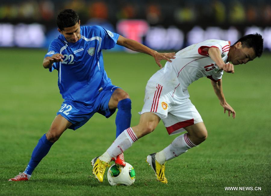 Shohruh Gadoev (L) of Uzbekistan vies with Sun Ke of China during a friendly match in Hohhot, north China's Inner Mongolia Autonomous Region, June 6, 2013. Uzbekistan won the match 2-1. (Xinhua/Zhang Ling)