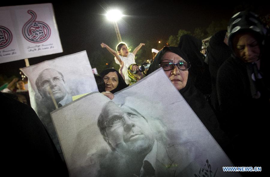 Supporters hold up posters of Tehran Mayor and presidential candidate Mohammad-Baqer Qalibaf during a campaign rally in Shahr-e Rey, south of Tehran, Iran, on June 7, 2013. Iran's 11th presidential election is scheduled for June 14. (Xinhua/Ahmad Halabisaz) 