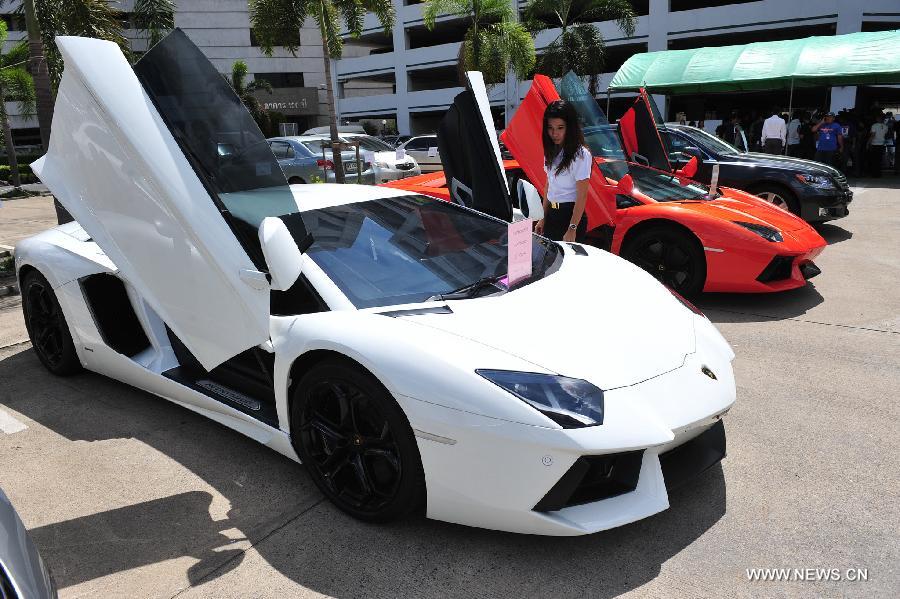 An official presents a smuggled Lamborghini Aventador LP700-4 luxury car during a press briefing at Thai Customs Department in Bangkok, Thailand, June 8, 2013. Thai Customs showcased the smuggled luxury cars, which worth over 129 million Thai baht (about 4.3 million U.S. dollars). (Xinhua/Rachen Sageamsak) 