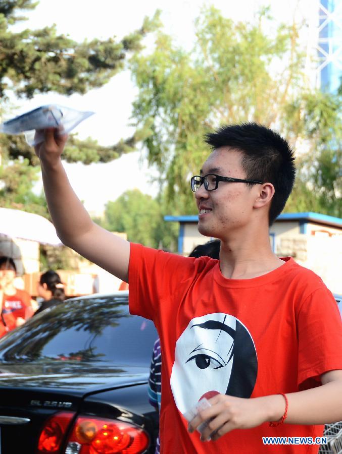 A student waves to his family after the college entrance examination in the No. 17 Middle School in Changchun, capital of northeast China's Jilin Province, June 8, 2013. The 2013 national college entrance examination ended in some regions of China on Saturday. Approximately 9.12 million people took part in the exam this year. (Xinhua/Lin Hong) 