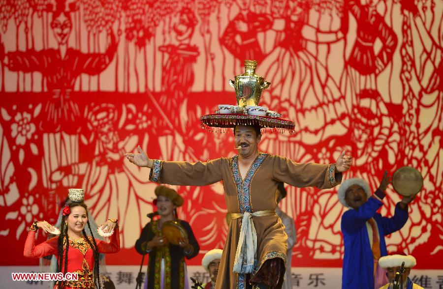 People perform dance during an activity to display local intangible cultural heritage in Changji, northwest China's Xinjiang Uygur Autonomous Region, June 8, 2013. (Xinhua/Jiang Wenyao)