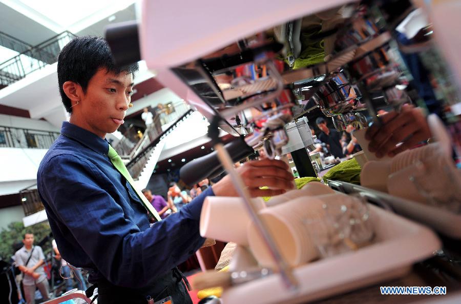 A barista competes during the 2nd Fushan Cup international Barista Championship of China in Chengmai, south China's Hainan Province, June 9, 2013. A total of 24 baristas around the world participated in the championship. (Xinhua/Guo Cheng) 