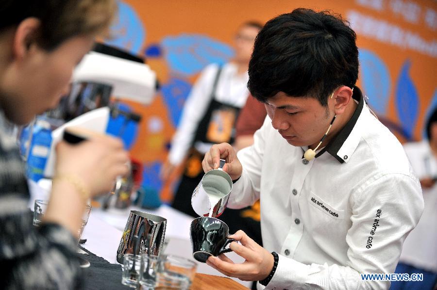 A barista competes during the 2nd Fushan Cup international Barista Championship of China in Chengmai, south China's Hainan Province, June 9, 2013. A total of 24 baristas around the world participated in the championship. (Xinhua/Guo Cheng) 