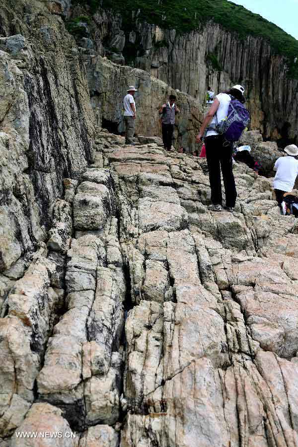 Tourists visit the South Ninepin Island in Hong Kong, south China, June 9, 2013. The Ninepin Group, or Kwo Chau Islands, is a group of islands in the southeastern Hong Kong. (Xinhua/Li Peng) 