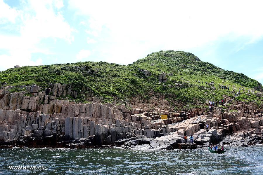 Tourists visit the North Ninepin Island in Hong Kong, south China, June 9, 2013. The Ninepin Group, or Kwo Chau Islands, is a group of islands in the southeastern Hong Kong. (Xinhua/Li Peng) 