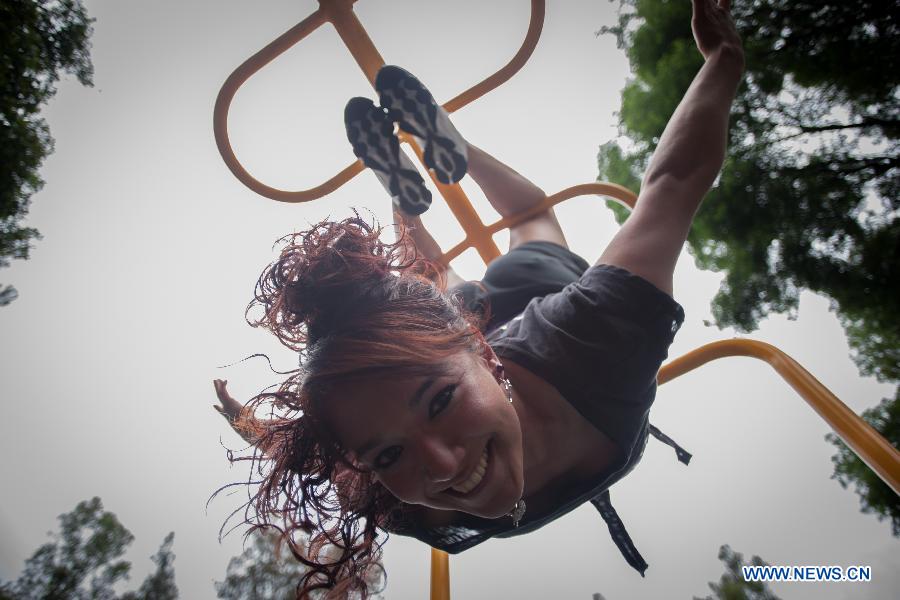 A woman practises pole dance on the Pole Dance National Day at a park in Mexico City, capital of Mexico, June 9, 2013. Mexican women gathered in parks around the country to practise pole dance June 9, the third Pole Dance National Day, or the Urban Pole National Day. The pole dance, practised as a sports event, has become popular among Mexican women. (Xinhua/Pedro Mera)