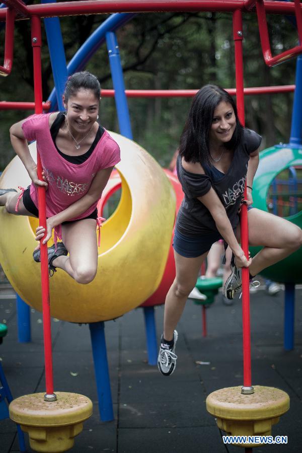 in parks around the country to practise pole dance June 9, the third Pole Dance National Day, or the Urban Pole National Day. The pole dance, practised as a sports event, has become popular among Mexican women. (Xinhua/Pedro Mera)