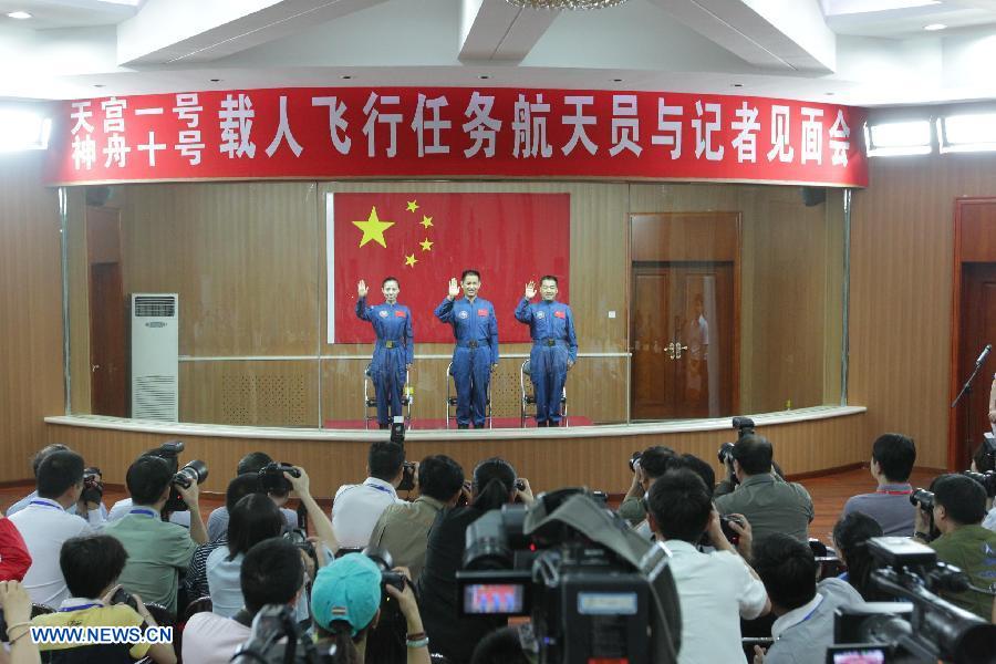 The three astronauts of the Shenzhou-10 manned spacecraft mission, Nie Haisheng (C), Zhang Xiaoguang (R) and Wang Yaping, meet the media at the Jiuquan Satellite Launch Center in Jiuquan, northwest China's Gansu Province, June 10, 2013. The Shenzhou-10 manned spacecraft will be launched at the Jiuquan Satellite Launch Center at 5:38 p.m. Beijing Time (0938 GMT) June 11. (Xinhua/Li Gang)