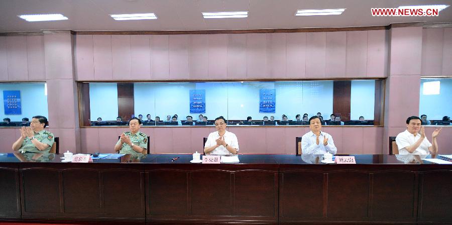 Chinese Premier Li Keqiang (C) and Liu Yunshan (2nd R), a member of the Standing Committee of the Political Bureau of the Communist Party of China Central Committee, watch a live broadcast of the launch of the manned Shenzhou-10 spacecraft at the Beijing Aerospace Control Center in Beijing, capital of China, June 11, 2013. (Xinhua/Li Tao)