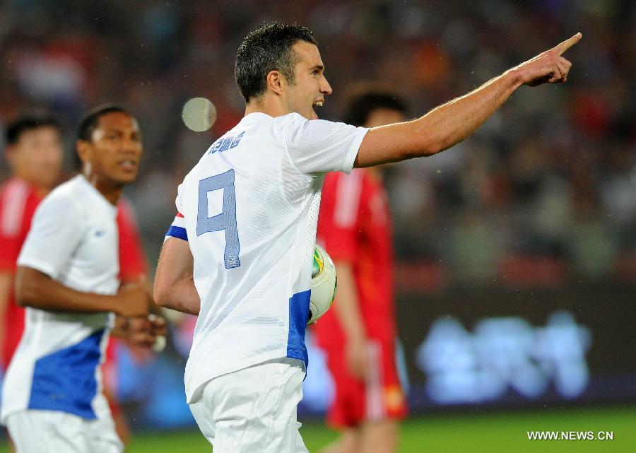 Robin van Persie of the Netherlands celebrates scoring a goal by penalty kick during the international friendly soccer match against China at the Workers Stadium in Beijing, capital of China, June 11, 2013. (Xinhua/Gong Lei) 