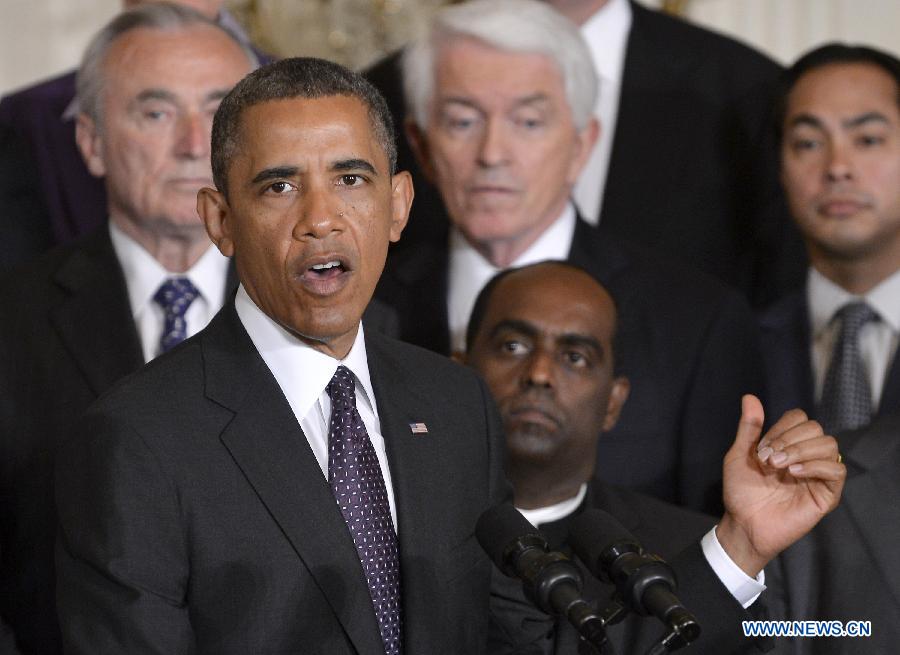 U.S. President Barack Obama (C) speaks on immigration reform during an event in the East Room of the White House in Washington D.C., capital of the United States, June 11, 2013. U.S. President Barack Obama on Tuesday urged lawmakers to pass the comprehensive immigration reform bill, as the full Senate began floor debate over the bill. (Xinhua/Zhang Jun) 