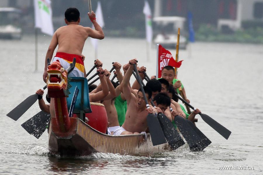 Participants compete in a boat race held to mark the annual Dragon Boat Festival on the Mochou Lake, Nanjing, east China's Jiangsu Province, June 10, 2013. This year's Dragon Boat Festival falls on June 12. (Xinhua/Han Hua)