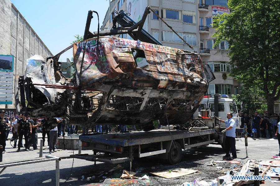 Police remove roadblocks in the Taksim Square in Istanbul, Turkey, on June 11, 2013. Turkish riot police fired water cannon and teargas at hundreds of protesters in Istanbul's Taksim Square on Tuesday, entering the square for removing the roadblocks and cleanning up flags and banners. Demonstrators fought back with stones and fireworks. (Xinhua/Lu Zhe)