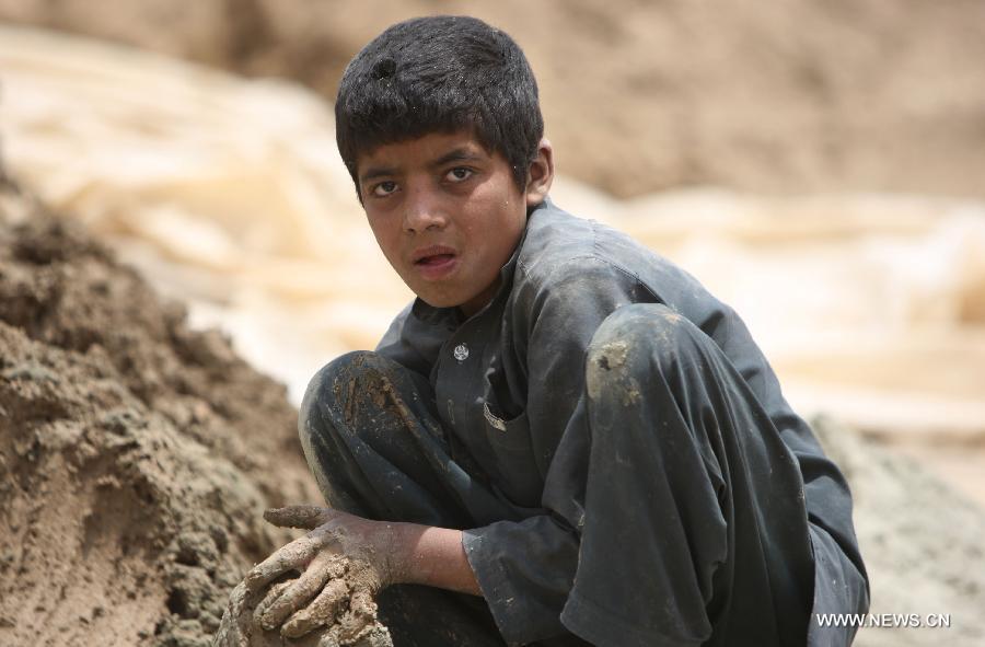 An Afghan child works at a brick factory in Kabul, Afghanistan on June 12, 2013. Afghan labor children work as usual on June 12 while many countries around the world mark the day as the World Day Against Child Labor. The International Labor Organization (ILO) launched the World Day Against Child Labor in 2002, which falls on each June 12. (Xinhua/Ahmad Massoud) 