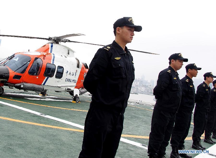 Crew members stand on the deck of the ship "Haixun 01" of China's Maritime Safety Administration (MSA) before leaving Shanghai, east China, June 10, 2013. The public service ship will conduct a 62-day voyage to visit Australia, Indonesia, Myanmar and Malaysia. (Xinhua/Chen Fei) 