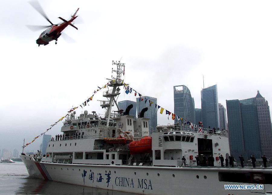 A helicopter and its support ship "Haixun 01" of China's Maritime Safety Administration (MSA) leaves Shanghai, east China, June 10, 2013. The public service ship will conduct a 62-day voyage to visit Australia, Indonesia, Myanmar and Malaysia. (Xinhua/Chen Fei)