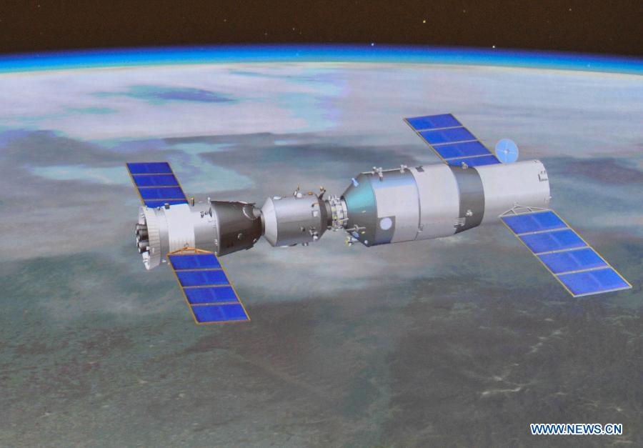 Photo taken on June 13, 2013 shows the screen at the Beijing Aerospace Control Center showing a simulated picture of an automated docking between the Shenzhou-10 manned spacecraft and the orbiting Tiangong-1 space module. China's Shenzhou-10 manned spacecraft successfully completed an automated docking with the orbiting Tiangong-1 space module at 1:18 p.m. Thursday. (Xinhua/Liu Chan)