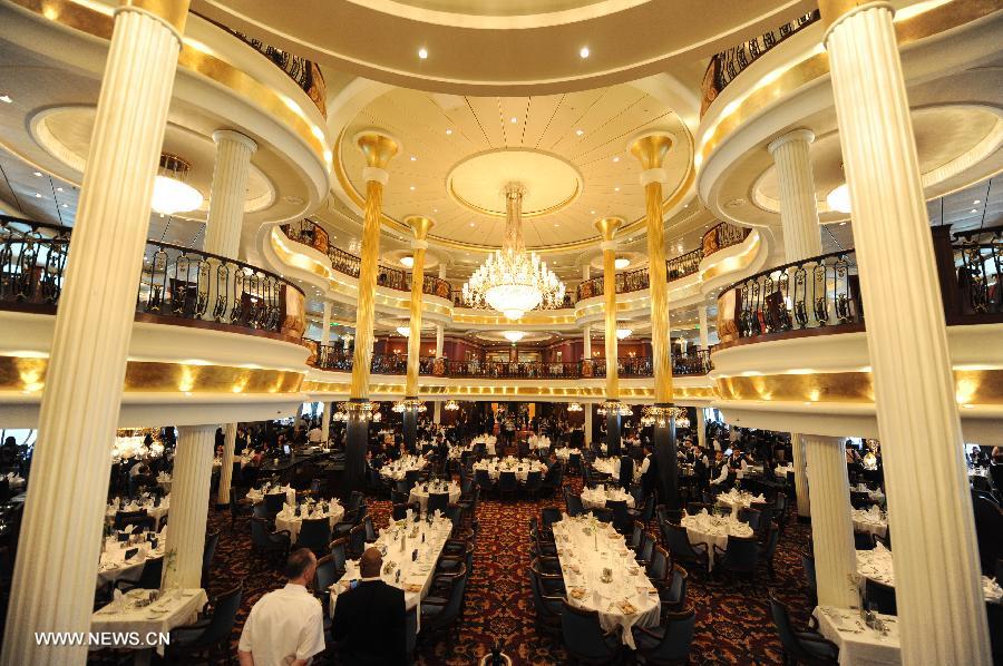 The dining room is pictured on cruise liner Mariner of the Seas through windows at the Kai Tak Cruise Terminal in Hong Kong, south China, June 13, 2013. The new cruise terminal, built at the end of the runway of the former Kai Tak Airport, received its first liner, Mariner of the Seas on June 12, which has a capacity of 3,807 people. (Xinhua/Lui Siu Wai)