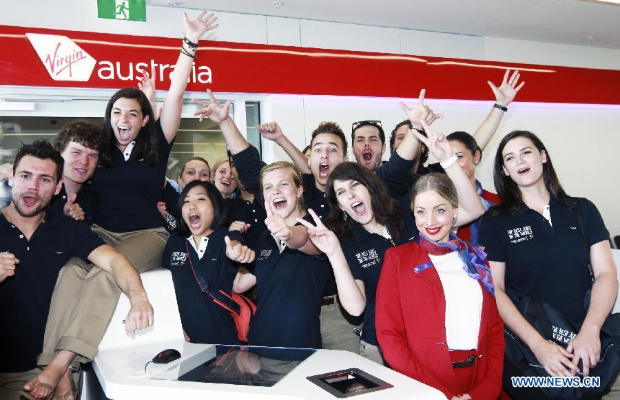 Finalists from 12 countries and regions pose for photos at the airport in Sydney, Australia, June 13, 2013. A total of 18 finalists arrived in Sydney Thursday, competing for the Best Jobs in the World including the Chief Funster in New South Wales, Lifestyle Photographer in Melbourne, Outback Adventurer in Northern Territory, Park Ranger in Queensland, Taste Master in Western Australia, and Wildlife Caretaker in South Australia. (Xinhua/Jin Linpeng)