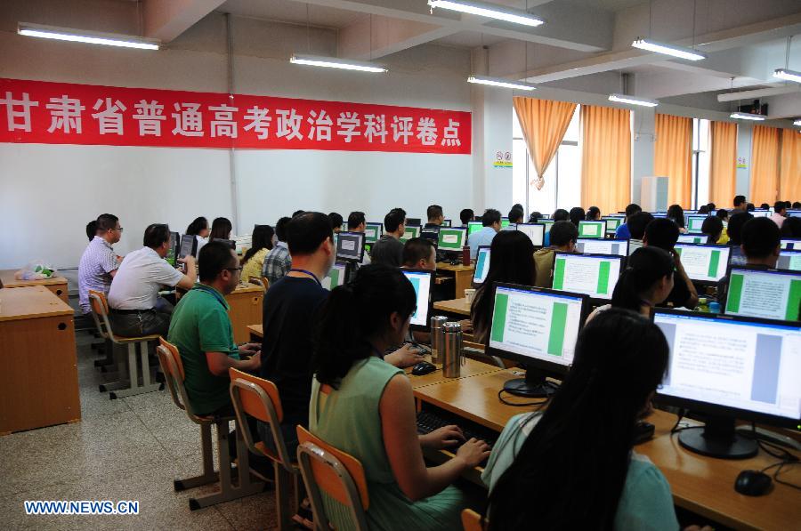 College entrance exam paper marking staff work at a paper marking room for the politics subject in the Northwest Normal University in Lanzhou, capital of northwest China's Gansu Province, June 13, 2013. In total 2,150 paper marking staff members need to mark the exam papers of 283,424 participants of 2013 college entrance exam in Gansu from June 10 to June 22. (Xinhua/Fan Peikun)