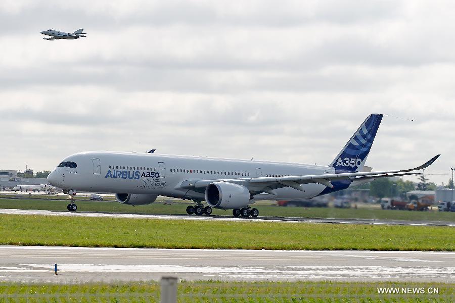 Airbus's A350 XWB (eXtra Wide Body) plane is about to take off from Toulouse-Blagnac airport, southwestern France, on its first test flight on June 14, 2013. The A350 XWB is Airbus' all-new mid-size long range product line. To date it has already won 613 firm orders from 33 customers worldwide. (Xinhua/Chen Cheng)