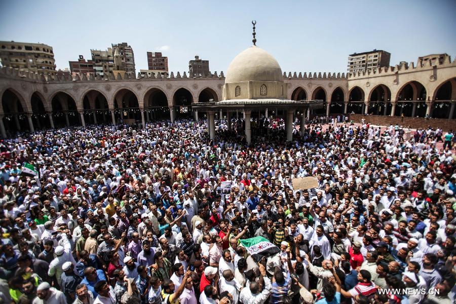 Egyptian protesters shout slogans during a protest against the Syrian president Bashar Al-Assad and supporting the Syrian uprising in the historical mosque of Amr ibn Al-As in old Cairo, Egypt, June 14, 2013. (Xinhua/Amru Salahuddien)