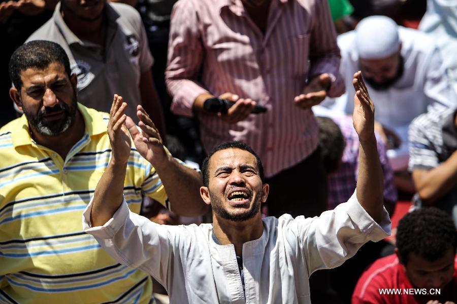 Egyptian protesters shout slogans during a protest against the Syrian president Bashar Al-Assad and supporting the Syrian uprising in the historical mosque of Amr ibn Al-As in old Cairo, Egypt, June 14, 2013. (Xinhua/Amru Salahuddien)