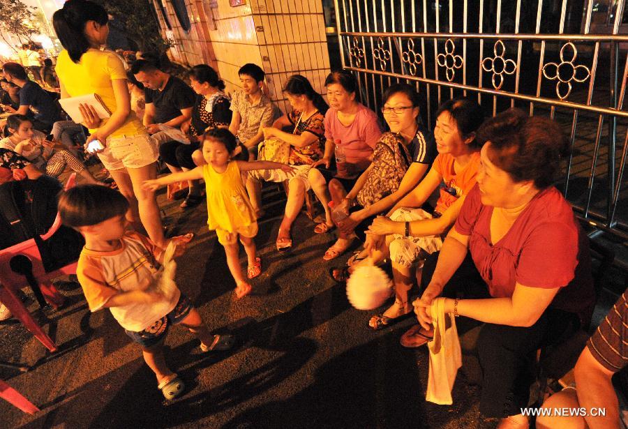 Parents queue at the gate of the Kindergarten of the Gubu Road of Liuzhou City, south China's Guangxi Zhuang Autonomous Region, June 14, 2013. Most kindergartens in Liuzhou started the registration for new students on June 15 and 16, when some parents who wanted to send their children into public kindergartens queued for the whole night for the registration. There are more than 200 kindergartens in Liuzhou City, in which only 14 are public ones. Attracted by the low costs and good reputation of the public kindergartens which often enroll limited number of students every year, some parents spare no effort in striving for the registration. Many parents even queue for the whole night for the registration, which has become a common phenomenon in many places of the country. (Xinhua/Li Bin)