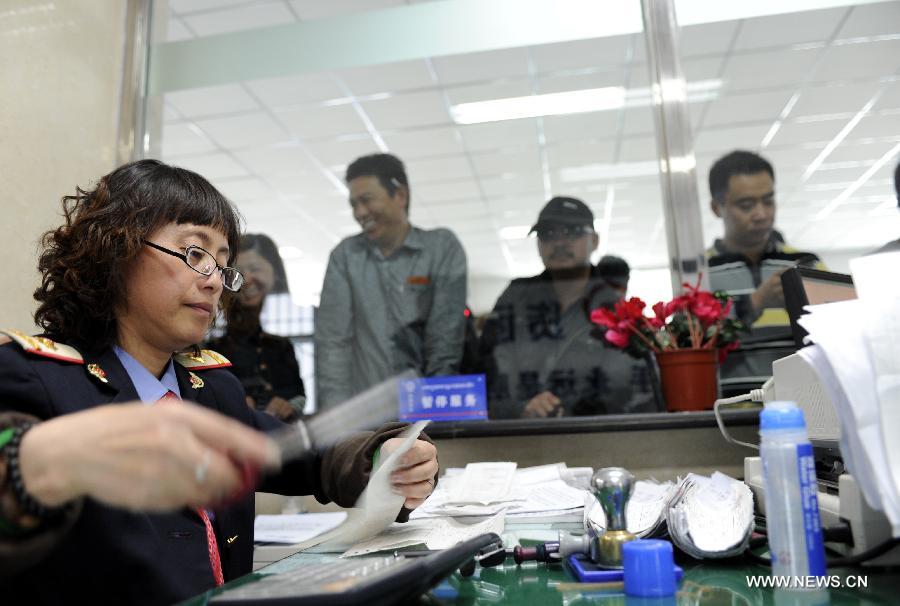 A railway employee works behind a counter offering freight transport service at the Lhasa West Railway Station in Lhasa, capital of southwest China's Tibet Autonomous Region, June 15, 2013. The China Railway Corporation, a commercial arm separated from the nation's ex-railways ministry, said Saturday that it will push its freight transport services to cover a bigger market. A company spokesman said it will work toward that goal through a slew of reforms focused on efficiency and better services, in efforts to transform the company's freight transport into a modern logistics business. (Xinhua/Chogo) 