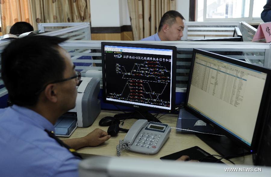 Train dispatchers work in their office at the Lhasa West Railway Station in Lhasa, capital of southwest China's Tibet Autonomous Region, June 15, 2013. The China Railway Corporation, a commercial arm separated from the nation's ex-railways ministry, said Saturday that it will push its freight transport services to cover a bigger market. A company spokesman said it will work toward that goal through a slew of reforms focused on efficiency and better services, in efforts to transform the company's freight transport into a modern logistics business. (Xinhua/Chogo) 