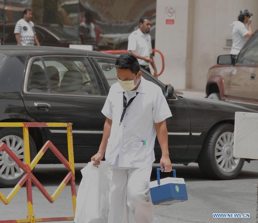 A health worker walks out of a hospital in the eastern Saudi Arabia city of Khobar, on June 17, 2013. Four more people have died in Saudi Arabia from SARS-like coronavirus, Saudi Arabia's Health Ministry said, bringing to 32 the number of death from the desease in the kingdom, 49 the number of infection. (Xinhua/Wang Bo) 