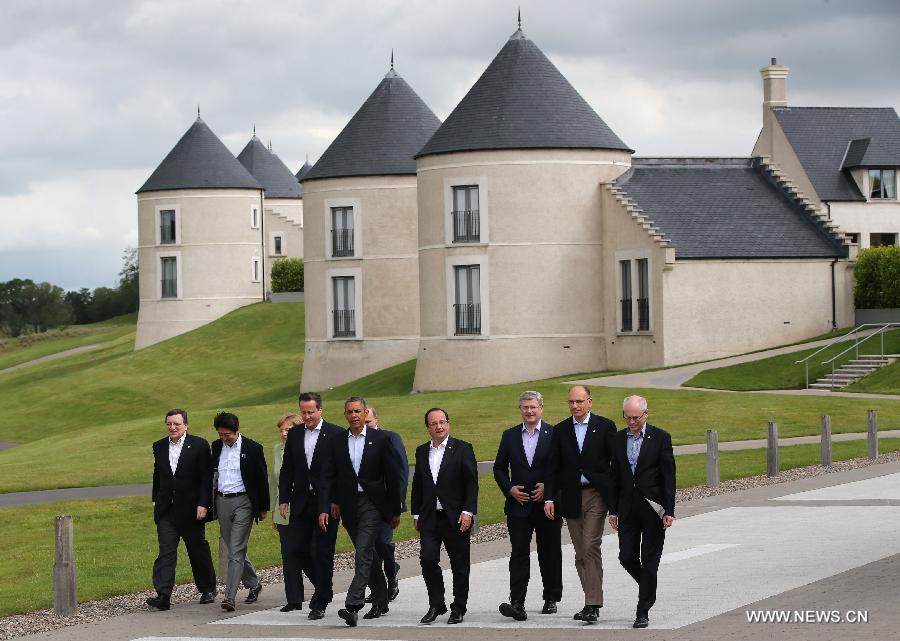 (L-R) European Commission President Jose Manuel Barroso, Japanese Prime Minister Shinzo Abe, German Chancellor Angela Merkel, British Prime Minister David Cameron, US President Barack Obama, Russian President Vladimir Putin, French President Francois Hollande, Canadian Prime Minister Stephen Harper, Italian Prime Minister Enrico Letta and European Council President Herman Van Rompuy walk to the podium for a group photo at the Lough Erne resort near Enniskillen in Northern Ireland, UK, June 18, 2013. G8 and EU leaders gathered in Lough Erne on Tuesday for the second and final day of their summit.(Xinhua/Yin Gang) 