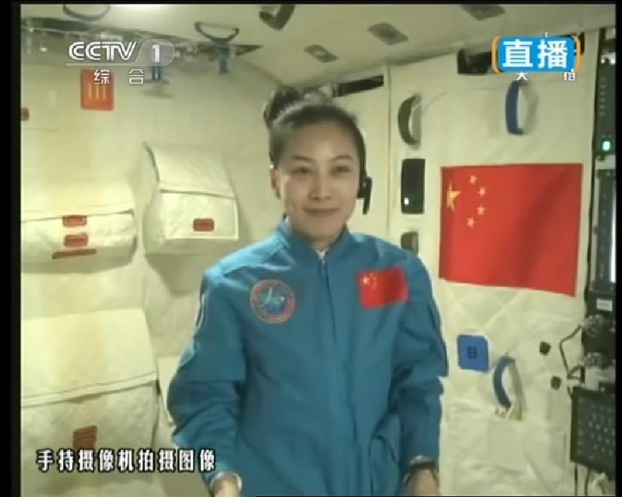 This TV grab taken on June 20, 2013 shows female astronaut Wang Yaping, one of the three crew members of Shenzhou-10 spacecraft, giving a lecture to students on Earth aboard China's space module Tiangong-1. A special lecture began Thursday morning, given by Wang Yaping aboard China's space module Tiangong-1 to students on Earth. (Xinhua)